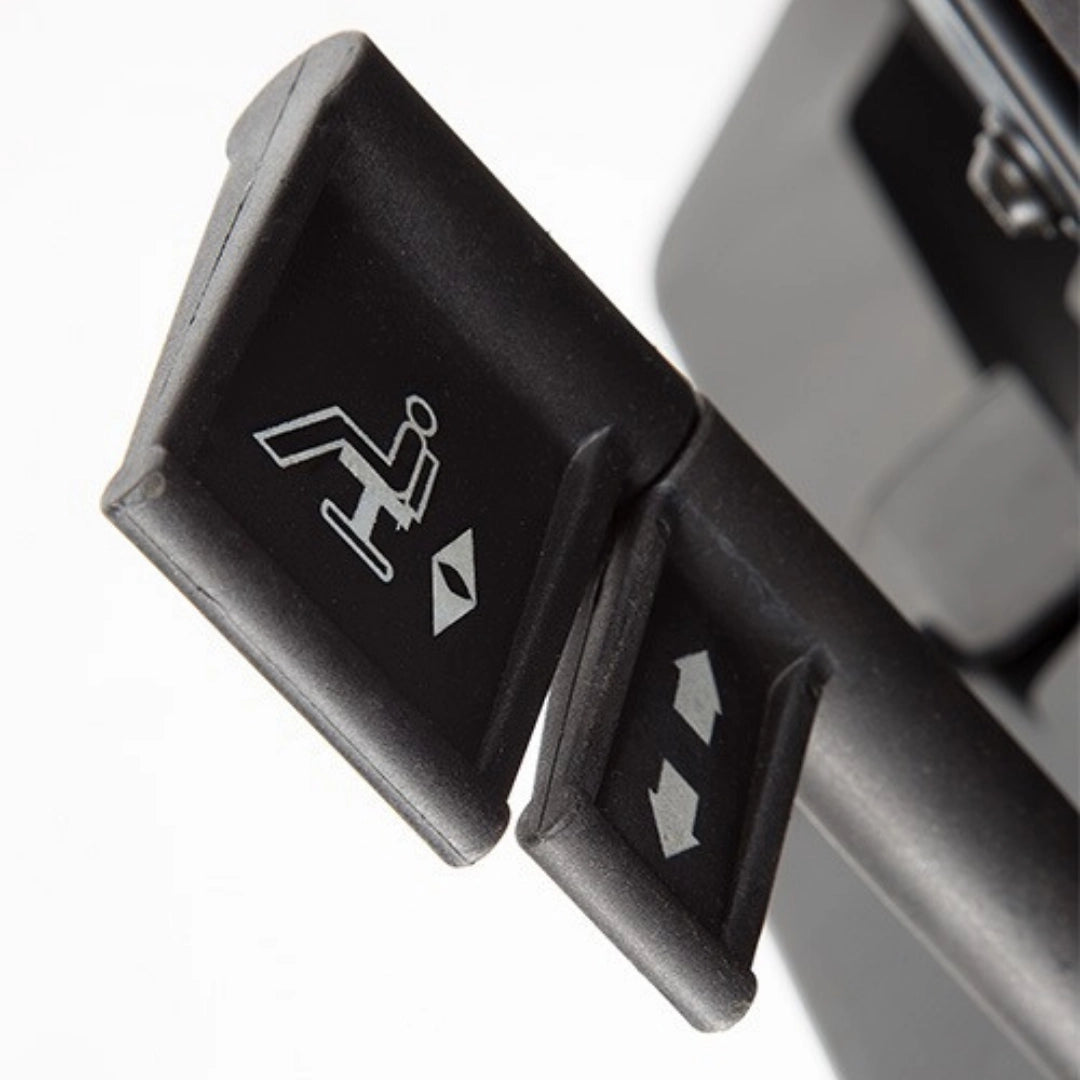 The product is an ergonomic office chair, specifically the "Ergonomic Office Chair Basic." The image shows the control levers for adjusting the chair's features, including a reclining mechanism and height adjustment, indicated by relevant symbols. The design is practical, focusing on user comfort and functionality.