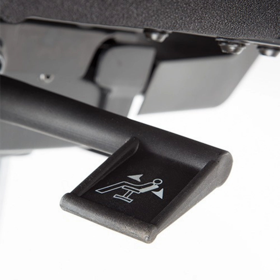 The product is an ergonomic office chair, likely from a basic line. The image shows a lever used for adjusting the chair's reclining feature, indicated by an icon of a person leaning back. The lever is designed for easy access and operation, enhancing user comfort.