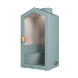 The product is an acoustic meeting pod designed for private conversations or focused work. It features a cottage-like design with a light blue exterior and a glass door, providing a cozy and soundproof environment. Inside, there is a bench for seating, making it suitable for individual or small group use.