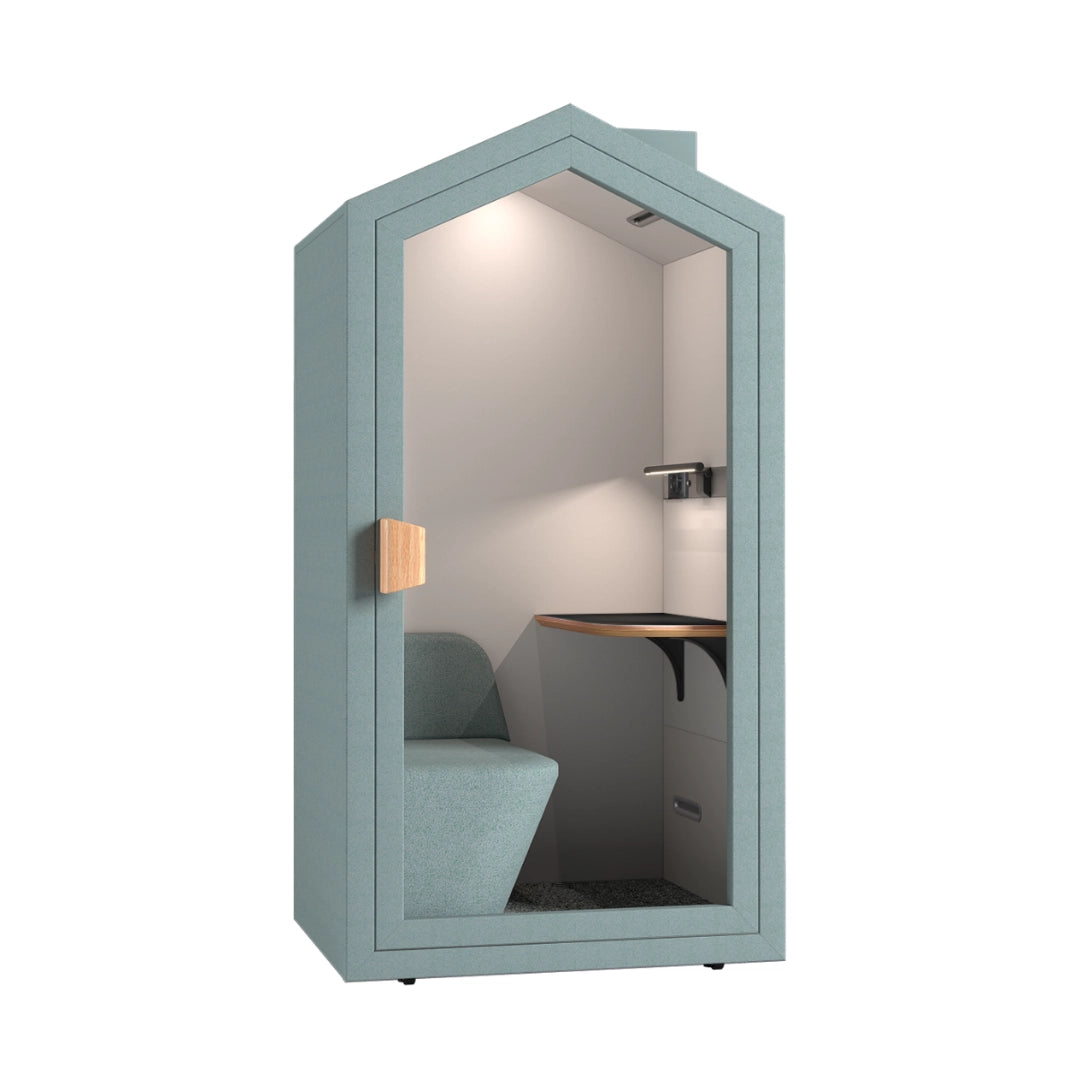 The product is an acoustic meeting pod designed for private conversations or focused work. It features a modern, cottage-like design with a soft blue exterior and a cozy interior that includes a small desk and a comfortable seat. The pod is equipped with lighting and soundproofing elements, making it suitable for office environments.