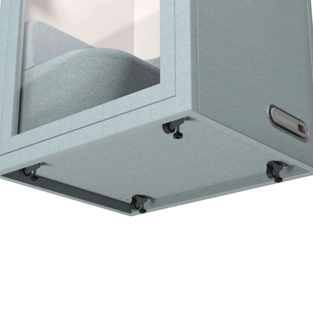 The product is an acoustic meeting pod, specifically the "Cottage" model. The image shows the bottom of the pod, highlighting its textured surface and adjustable feet or casters for stability. The design emphasizes sound insulation and a modern aesthetic, suitable for office environments.