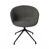 The product is a conference chair, characterized by its ergonomic design and modern aesthetic. It features a rounded, upholstered seat in a dark gray fabric, supported by a sleek black metal base with a four-legged design. The overall look is minimalist and stylish, suitable for office or conference settings.