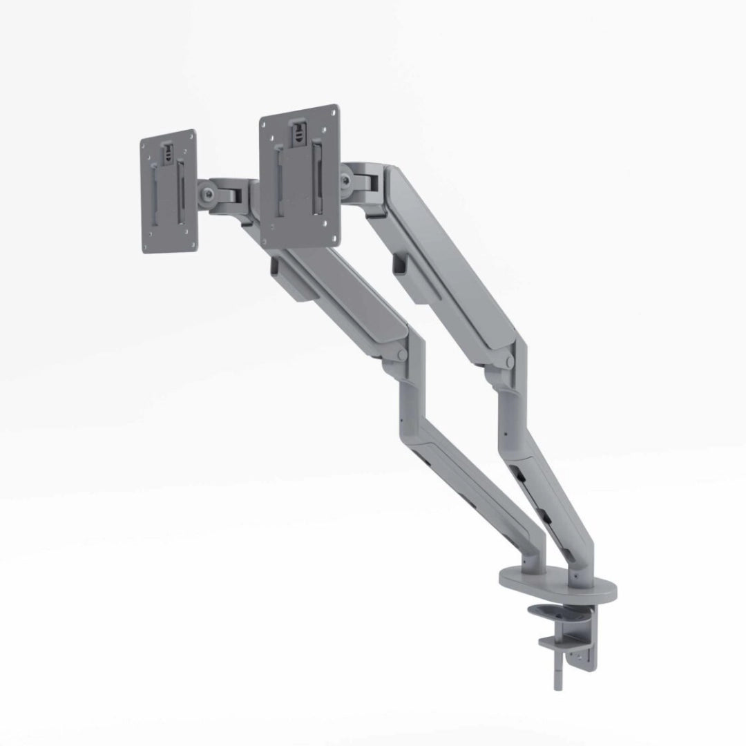 The product is a dual monitor arm designed for ergonomic use in an office setting. It features two adjustable arms that can hold two monitors, allowing for flexible positioning. The design is sleek and modern, with a gray finish, and it includes a mounting base for easy installation on a desk.