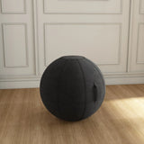 The product is an ergonomic seating ball designed for active sitting. It appears to be a modern, black fabric ball with a handle for easy transport. The setting features a wooden floor and a plain wall, emphasizing the ball's design.