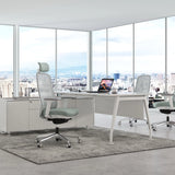 The image features an ergonomic office chair, likely from the brand Glory, designed for comfort and support during long hours of work. The chair has a mesh back and a soft seat cushion, positioned in a modern office environment with large windows showcasing a city view. A sleek desk with a laptop and a coffee cup is also visible, enhancing the contemporary workspace aesthetic