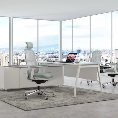 The image features an ergonomic office chair, likely from the brand Glory, designed for comfort and support during long hours of work. The chair has a mesh back and a soft seat cushion, positioned in a modern office environment with large windows showcasing a city view. A sleek desk with a laptop and a coffee cup is also visible, enhancing the contemporary workspace aesthetic