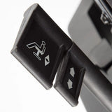 The product is an ergonomic office chair, specifically the "Ergonomic Office Chair Basic." The image shows the control levers for adjusting the chair's features, including a reclining mechanism and height adjustment, indicated by relevant symbols. The design is practical, focusing on user comfort and functionality.