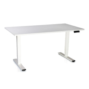 The image shows a standing desk, specifically the Supra model. It features a sleek, minimalist design with a white tabletop and silver legs. The desk is adjustable in height, indicated by a control panel on the side, making it suitable for both standing and sitting positions.