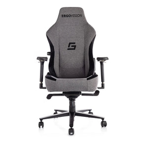 The product is an ergonomic gaming chair, specifically the Ergovision model. The chair features a sleek design with a gray fabric upholstery and black accents. It has adjustable armrests and a high back for support, making it suitable for long gaming sessions. The brand logo is prominently displayed on the top of the chair.