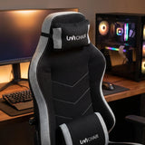 The product is an ergonomic office chair designed for gaming, specifically the UVI Alpha model. The image shows a sleek black and gray chair with a high back, featuring a headrest and lumbar support, set against a modern workspace with a computer monitor and a gaming PC in the background.
