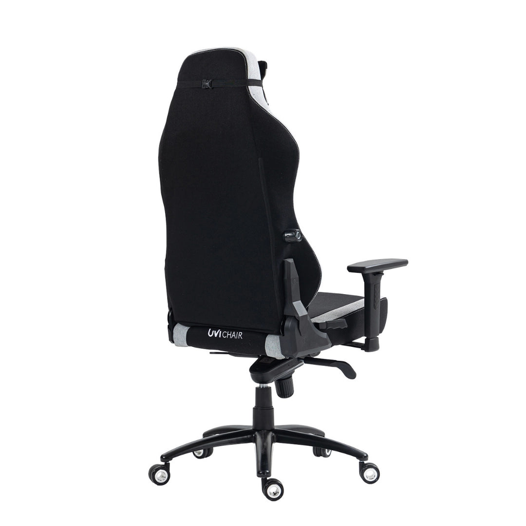 The product is an ergonomic office chair designed for gaming, specifically the UVI Alpha model. The image shows the chair from the side, highlighting its tall backrest, adjustable armrests, and a sleek, modern design with a combination of black and gray materials. The chair is mounted on a five-point base with wheels for mobility.