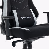 The product is an ergonomic office chair designed for gaming, specifically the UVI Alpha model. The image shows a close-up of the chair's seat and backrest, featuring a sleek black fabric with gray accents. The chair includes adjustable armrests and a lumbar support cushion, enhancing comfort for extended use. The UVI Chair logo is prominently displayed on the
