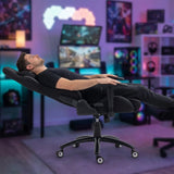 The image features a gaming ergonomic office chair, specifically the UVI Back in Black model. It shows a person reclining in the chair, which has a sleek black design and adjustable armrests. The background includes gaming monitors and colorful lighting, creating a vibrant gaming environment.