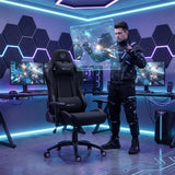 The image features an ergonomic office chair designed for gaming, specifically the UVI Chair model in black. The scene depicts a modern gaming setup with two monitors displaying a space-themed game, and a person in futuristic attire interacting with a holographic display. The room is illuminated with vibrant LED lights, enhancing the gaming atmosphere.