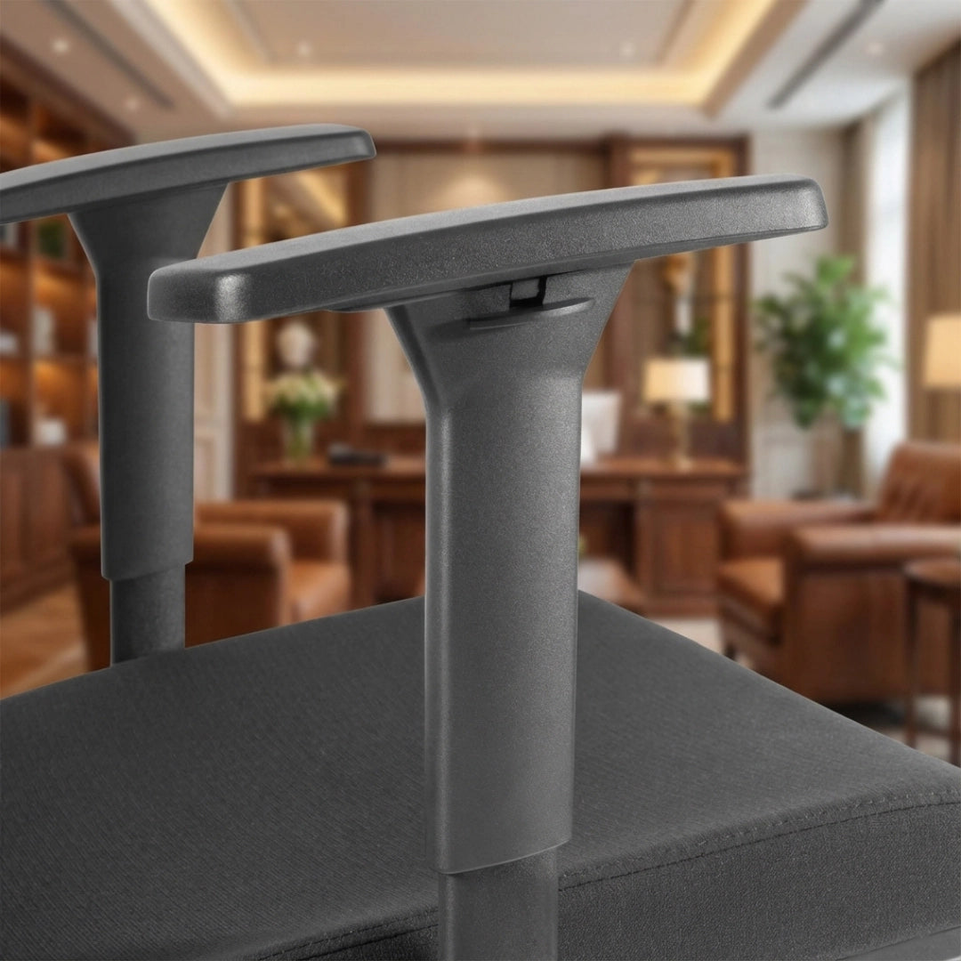 The product is an ergonomic office chair, specifically the UVI Focus model. The image shows a close-up of the chair's armrests and seat, highlighting their sleek design and sturdy construction. The background features a well-furnished office space, suggesting a professional setting.