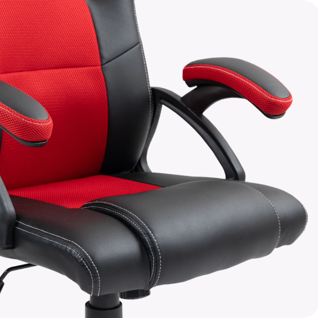 The product is an ergonomic office chair designed for gaming, specifically the UVI Hero model in red. The image showcases the chair's seat and armrests, featuring a combination of black and red materials, with a mesh texture on the armrests for added comfort. The stitching detail adds a stylish touch to the overall design.