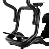 The product is a racing simulator seat, specifically the UVI Racing Seat Pro V2. The image shows a close-up of the seat's sturdy metal frame, featuring a sleek black finish and ergonomic design elements. It highlights the structural components, including the support bars and a footrest area, which are designed for enhanced stability and comfort during racing simulations.