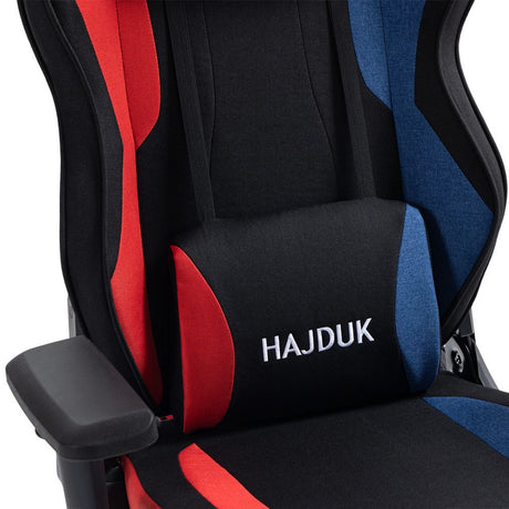The product is a gaming chair, specifically the UVI X Hajduk model. The chair features a sleek design with a combination of black, red, and blue fabric, and includes a lumbar support cushion. The brand name "Hajduk" is prominently displayed on the cushion, emphasizing its sporty aesthetic.