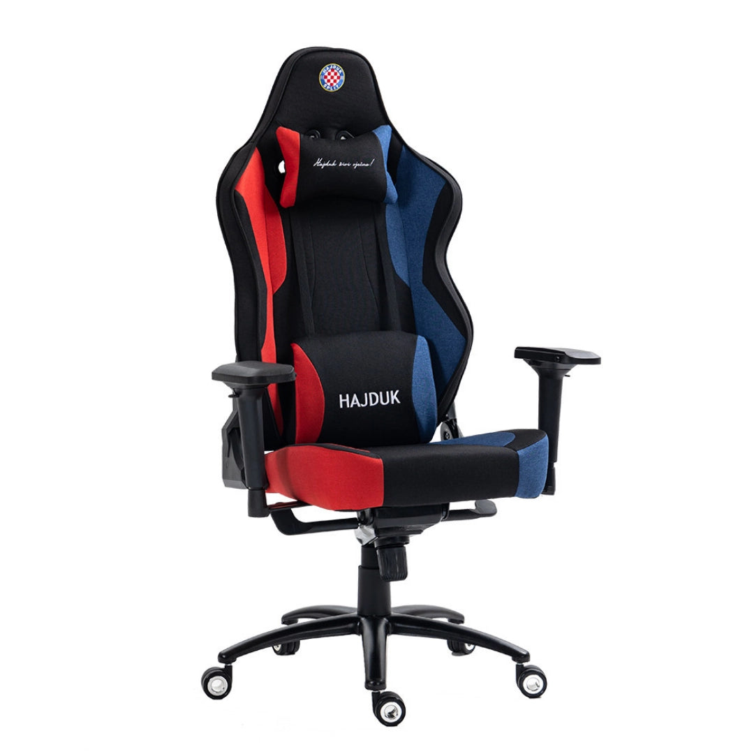 The product is a gaming chair, specifically the UVI X Hajduk model. It features a sporty design with a combination of black, red, and blue colors, and includes a headrest pillow. The chair is designed for comfort during long gaming sessions, with adjustable armrests and a high back for support.